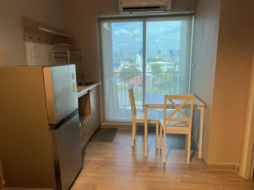 Compact kitchen and dining area with city view