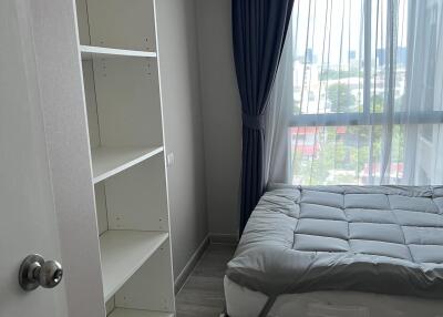 Bedroom with simple furnishings and an air conditioner