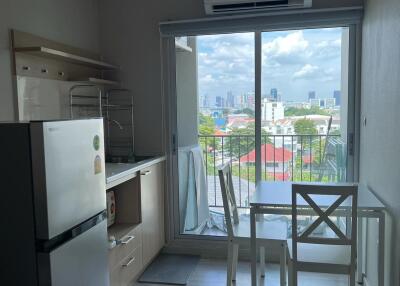 Compact kitchen and dining area with a view of the cityscape