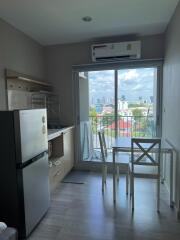 Compact kitchen and dining area with a view of the cityscape