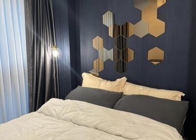 Cozy bedroom with modern decor and geometric wall art