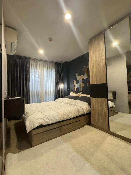 Modern bedroom with large window and bed