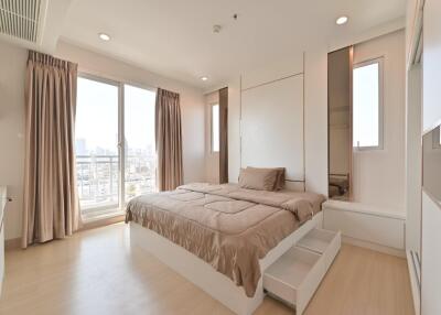 Modern bedroom with large window and city view