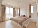 Modern bedroom with large window and city view