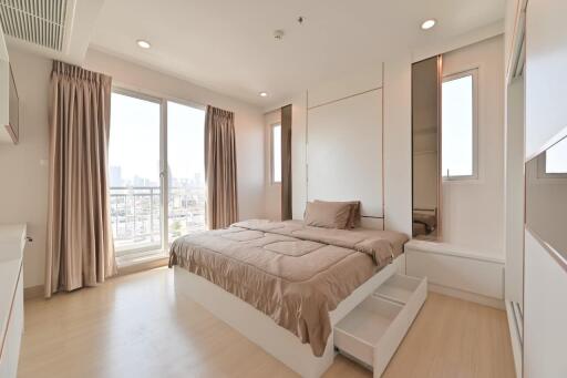 Modern bedroom with large window and city view