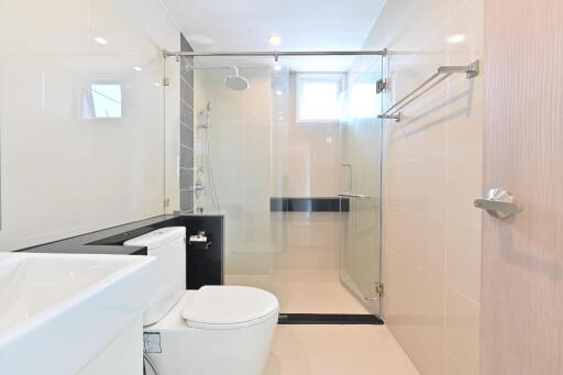 Modern bathroom with glass shower door and white fixtures