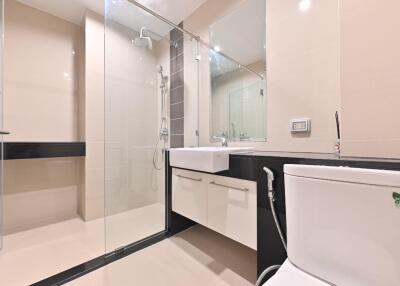 Modern bathroom with glass shower and white fixtures