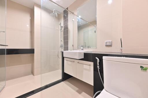 Modern bathroom with glass shower and white fixtures