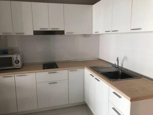 Modern white kitchen with ample storage and modern appliances