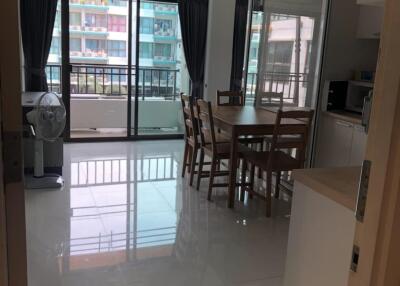 Modern dining area with large windows and balcony view