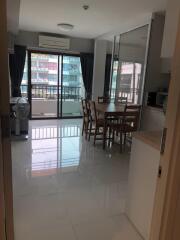 Modern dining area with large windows and balcony view