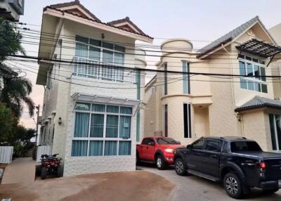 Exterior view of two modern houses with parked vehicles