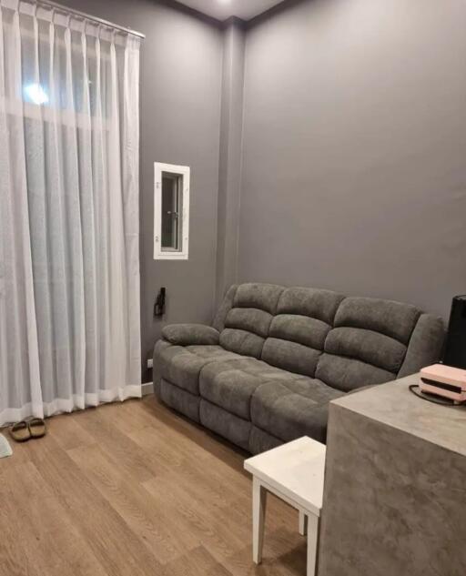 Living room with gray sofa and small table