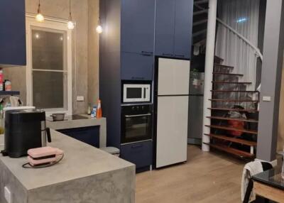 Modern kitchen with blue cabinets and spiral staircase