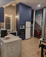 Modern kitchen with blue cabinets and spiral staircase