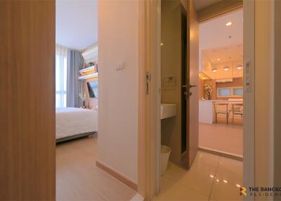 View from hallway leading to bedroom and kitchen in a modern apartment