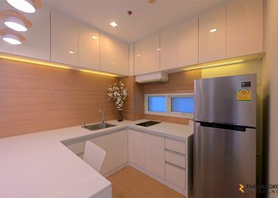 Modern kitchen with white cabinets and stainless steel appliances