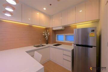 Modern kitchen with white cabinets and stainless steel appliances