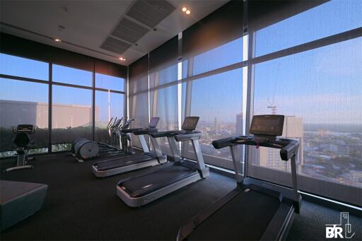 Modern fitness center with treadmills and city view