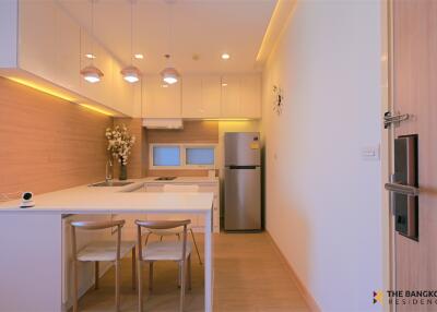 Modern kitchen with white cabinets and dining area