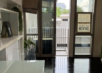 Modern living room with glass doors leading to a balcony