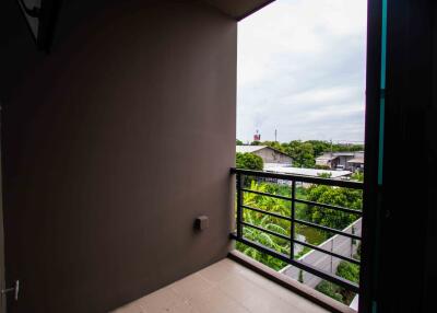 View from balcony with railing and surrounding neighborhood