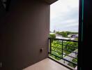 View from balcony with railing and surrounding neighborhood