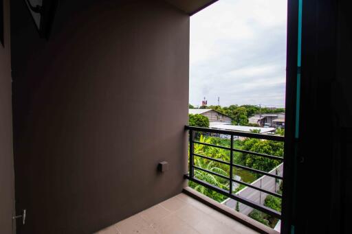 View from balcony with railing and surrounding neighborhood