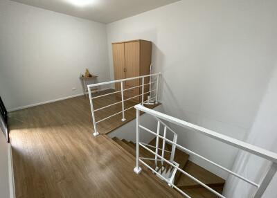 Second floor landing area with wooden flooring and white railing