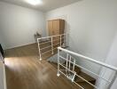 Second floor landing area with wooden flooring and white railing