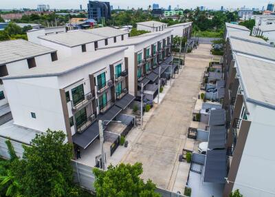 Aerial view of modern townhouses with driveways