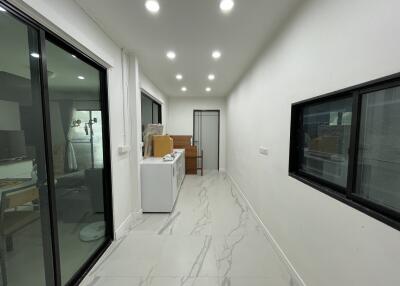 Utility room with laundry machines and storage