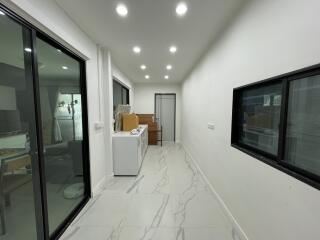 Utility room with laundry machines and storage