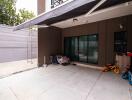 Covered outdoor patio with children's toys and closed garage door