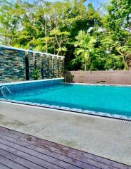 Outdoor swimming pool with lush greenery