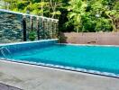 Outdoor swimming pool with lush greenery