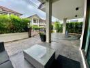 Outdoor patio area with tile flooring and seating