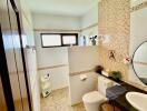 Modern bathroom with tiled walls, a round mirror, and a window