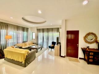 Spacious living room with sofas and a TV