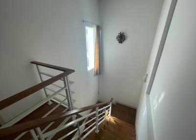 Bright stairway with wooden steps and modern railing