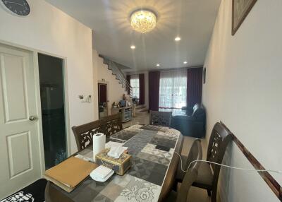 Spacious living and dining area with staircase