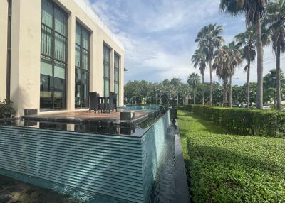 Outdoor pool with adjacent building and garden