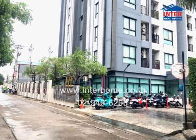 Modern apartment building exterior with motorcycles parked outside