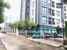 Modern apartment building exterior with motorcycles parked outside