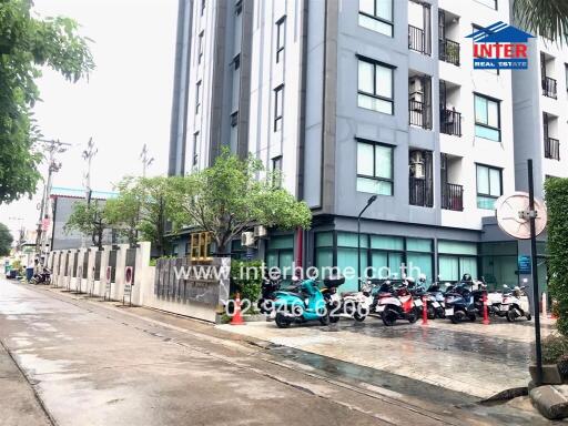 Modern apartment building exterior with motorcycles parked outside