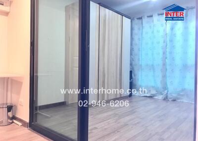 Spacious bedroom with sliding glass doors and large wardrobe