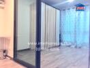 Spacious bedroom with sliding glass doors and large wardrobe