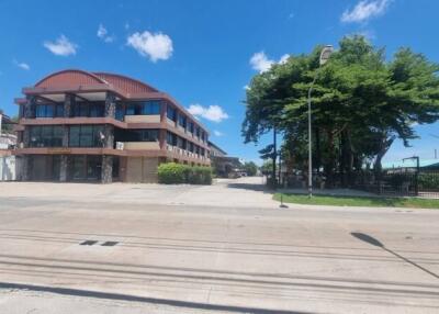 Exterior view of a building with a street and large trees