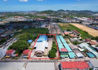 Aerial view of an urban area with industrial buildings and surrounding landscape