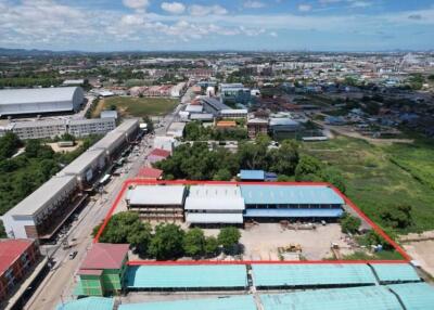 Aerial view of a property with surrounding buildings and landscape